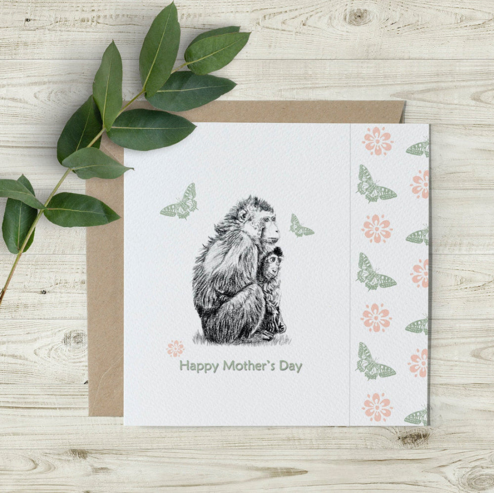 Hand-drawn Mother’s Day Monkey Card by Emma Gorton featuring a mother monkey and baby, with a unique cut-away edge and eco-friendly butterfly and flower design, sustainably made in the UK