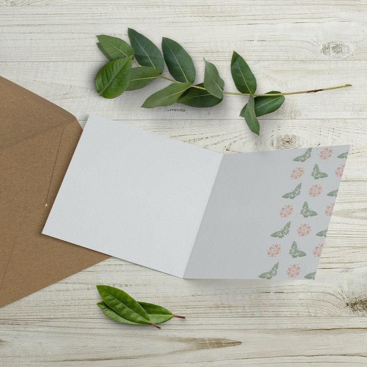 Inner design of eco-friendly Mother’s Day Monkey Card by Emma Gorton, featuring a pink and green butterfly and flower design revealed by cut-away edge, sustainably made in the UK