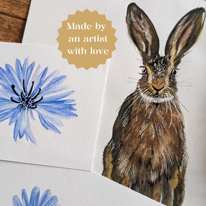 Finished hare and chicory watercolour sketches with “made by an artist with love” text