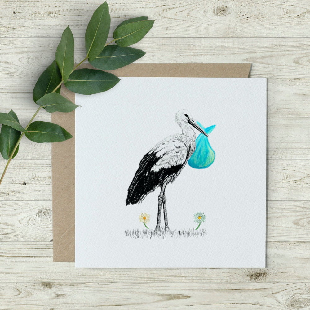 Gender-neutral baby card featuring a hand-drawn stork carrying a green cloth bundle, printed on eco-friendly textured paper. A percentage of sales supports wildlife charities.