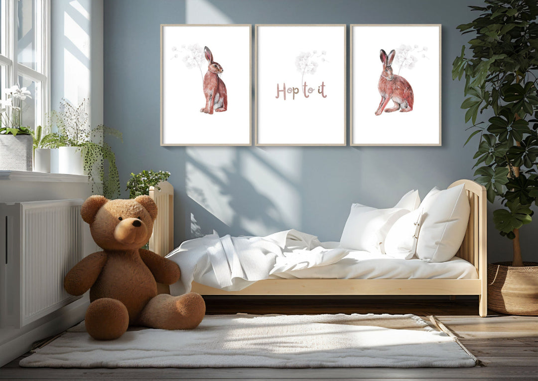 A beautifully styled child's room featuring three nature-inspired art prints on the wall—two hare sketches and the phrase "Hop to It"—perfect for licensed children's décor and wildlife-themed product collaborations.