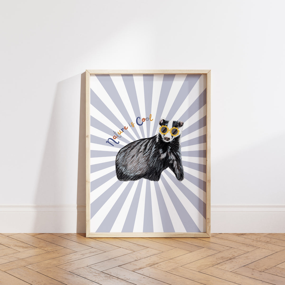Hand-drawn badger wearing yellow sunglasses with “Nature is Cool” text on a blue and white sunburst background, framed as a giclée art print.