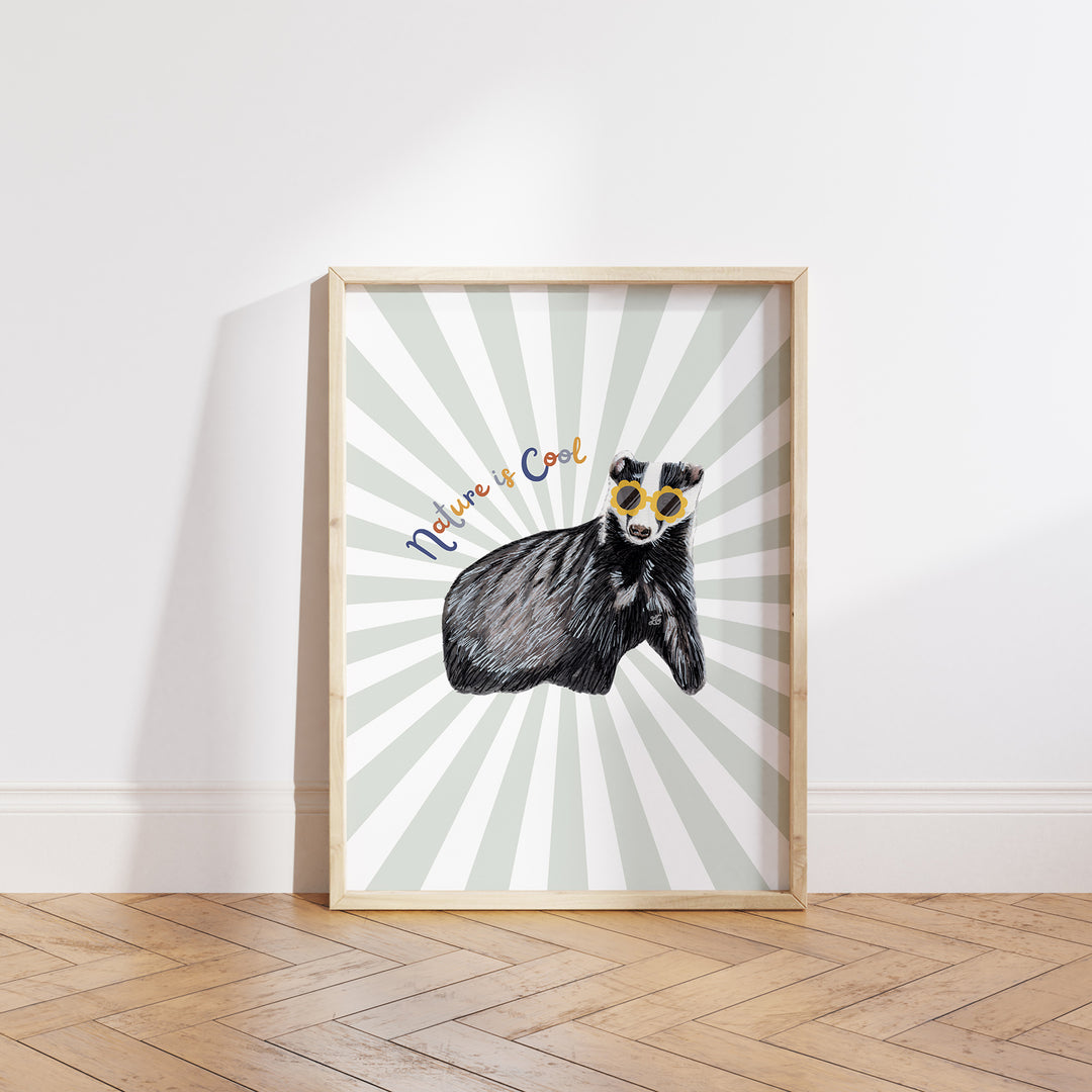 Hand-drawn badger wearing yellow sunglasses with “Nature is Cool” text on a green and white sunburst background, framed as a giclée art print.