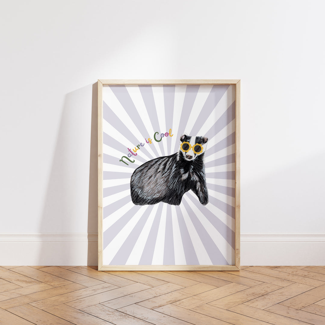 Hand-drawn badger wearing yellow sunglasses with “Nature is Cool” text on a lilac and white sunburst background, framed as a giclée art print.