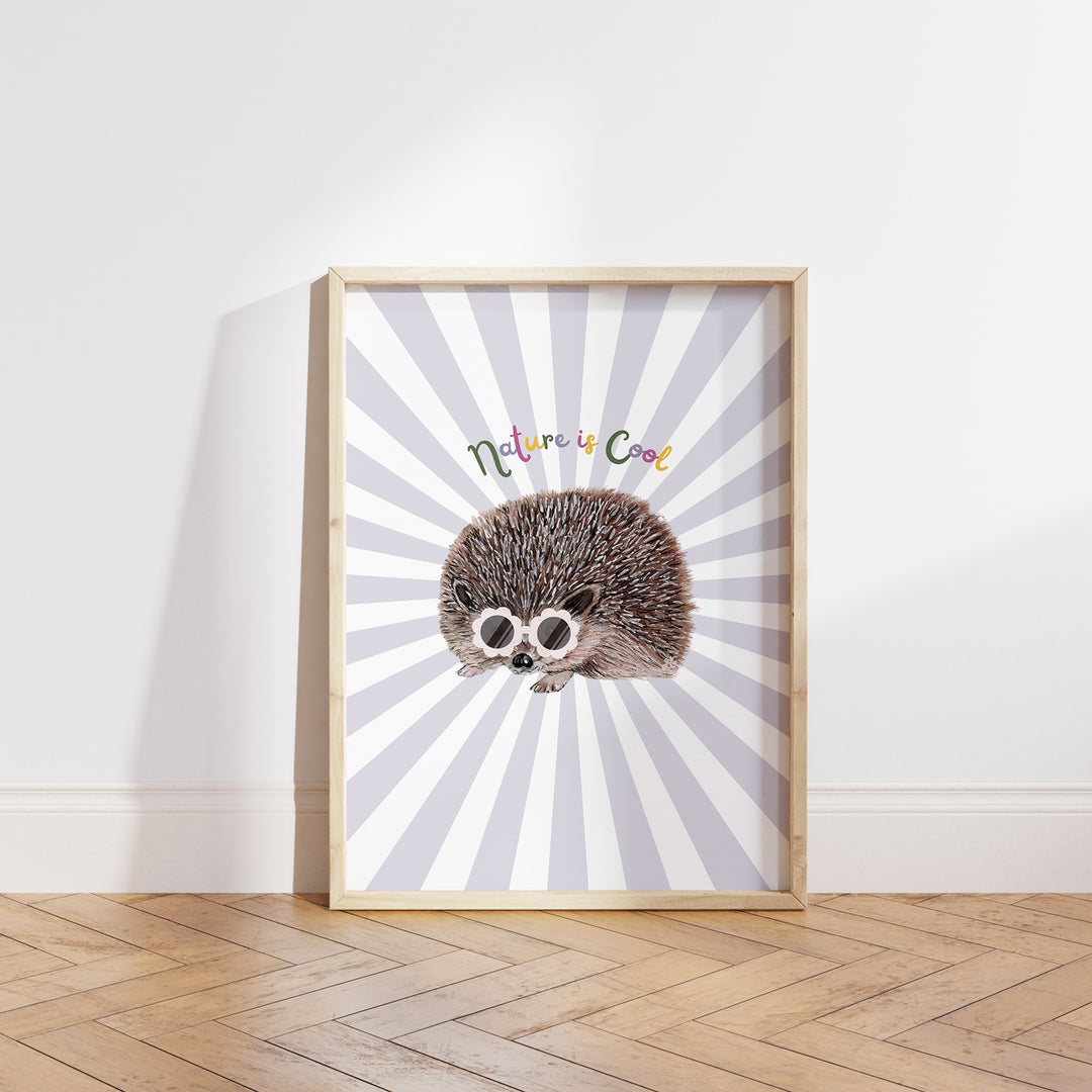 Hand-drawn hedgehog wearing pink sunglasses with “Nature is Cool” text on a lilac and white sunburst background, framed as a giclée art print.