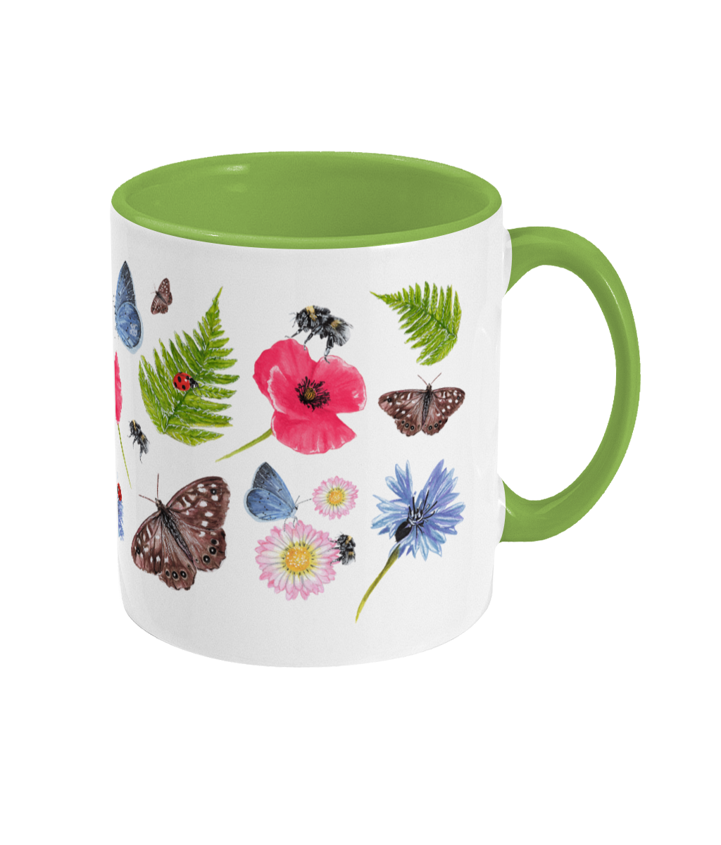 Right side of ceramic mug with lime green handle and bees, butterflies and wildflowers on white backdrop