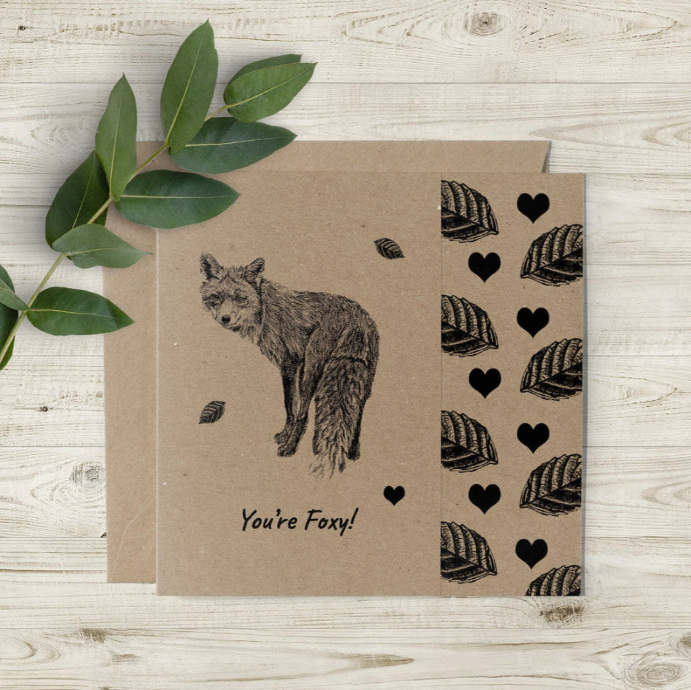 Eco-friendly "You’re Foxy" Valentine’s Day and anniversary card with hand-drawn fox, hearts, and leaves, featuring a charming cutaway edge, UK-made by Emma Gorton.